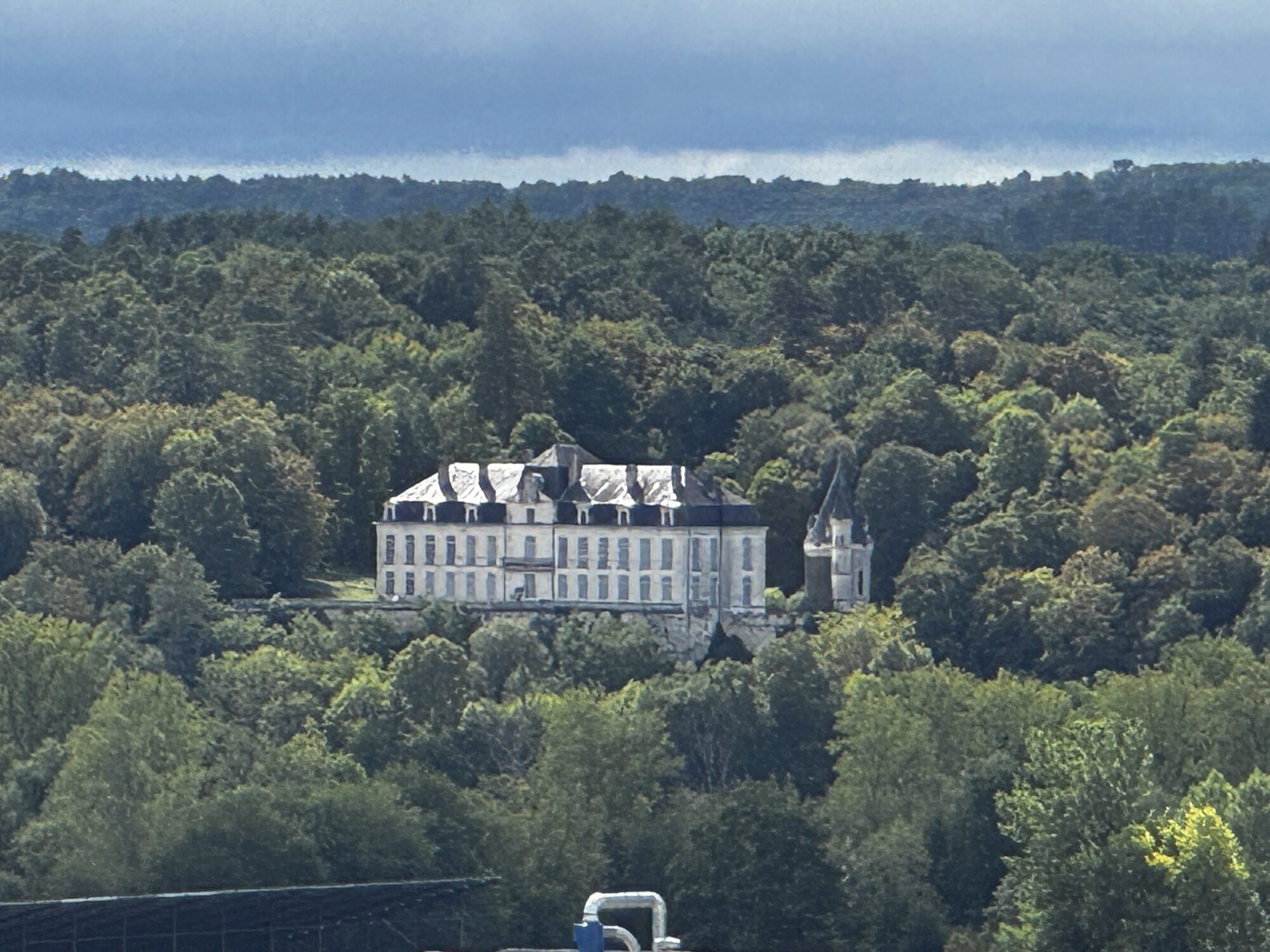 The neighbouring château seen across the wooded Dordogne landscape from Maison Rivers